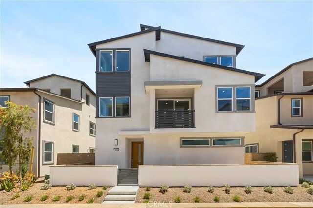 470 Lobata, Irvine, CA 92618 - view of front of property with stucco siding and a balcony