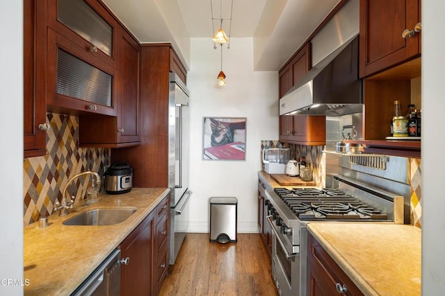 99 S Raymond Ave Unit 409, Pasadena, CA 91105 - kitchen with high quality appliances, wall chimney range hood, a sink, decorative backsplash, and light countertops