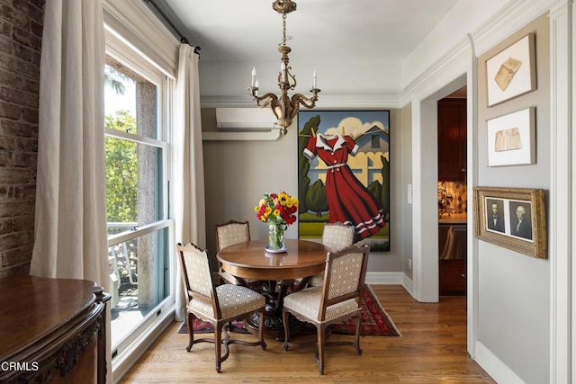 99 S Raymond Ave Unit 409, Pasadena, CA 91105 - dining room featuring a chandelier, baseboards, light wood-style flooring, and a wall mounted AC