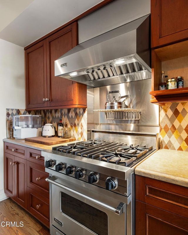 99 S Raymond Ave Unit 409, Pasadena, CA 91105 - kitchen with designer range, wall chimney range hood, light countertops, and decorative backsplash