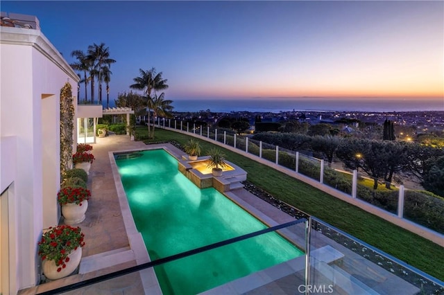 pool at dusk with a patio area, a pergola, a water view, and fence