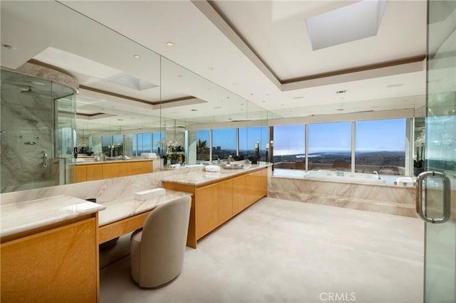 full bath featuring a raised ceiling, a stall shower, and vanity