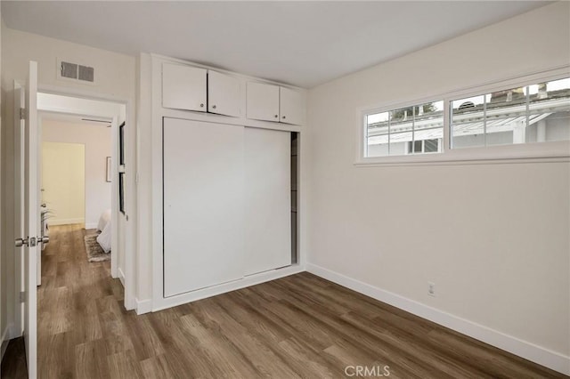 18017 Glenburn Ave, Torrance, CA 90504 - unfurnished bedroom with dark wood-style flooring, baseboards, and a closet