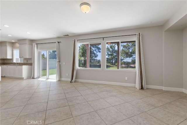 42631 Hussar Ct, Temecula, CA 92592 - unfurnished living room featuring plenty of natural light, baseboards, light tile patterned floors, and recessed lighting