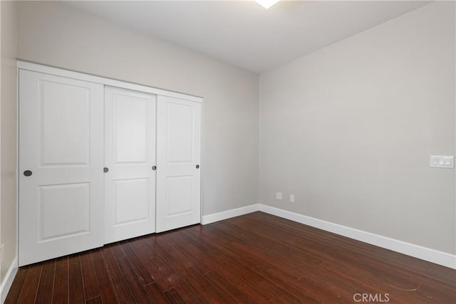 42631 Hussar Ct, Temecula, CA 92592 - unfurnished bedroom featuring baseboards, dark wood-type flooring, and a closet