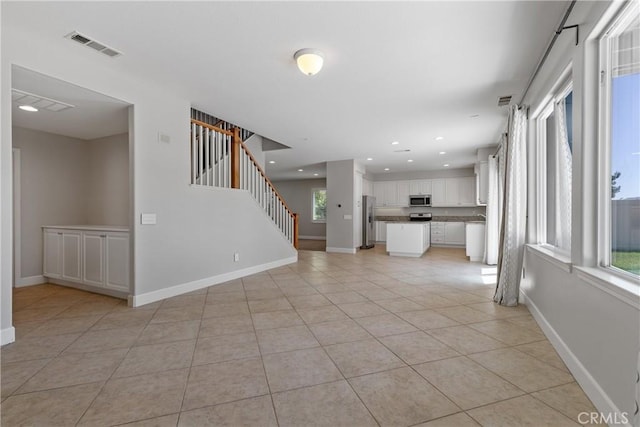 42631 Hussar Ct, Temecula, CA 92592 - unfurnished living room featuring plenty of natural light, baseboards, light tile patterned flooring, and recessed lighting