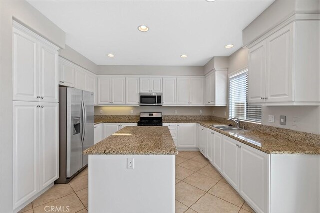 42631 Hussar Ct, Temecula, CA 92592 - kitchen with appliances with stainless steel finishes, a kitchen island, light tile patterned floors, white cabinetry, and recessed lighting