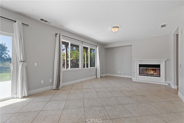 42631 Hussar Ct, Temecula, CA 92592 - unfurnished living room with light tile patterned flooring, a glass covered fireplace, and baseboards