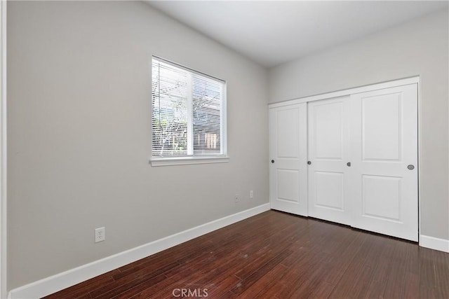 42631 Hussar Ct, Temecula, CA 92592 - unfurnished bedroom featuring baseboards, dark wood-style flooring, and a closet