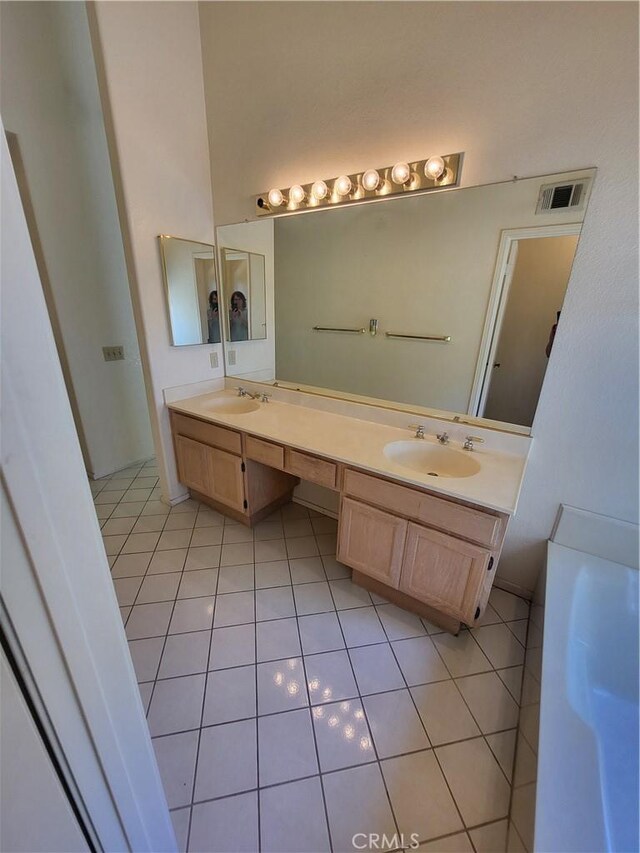 40132 Zamura Ct, Murrieta, CA 92562 - full bath with tile patterned floors, double vanity, and a bathtub