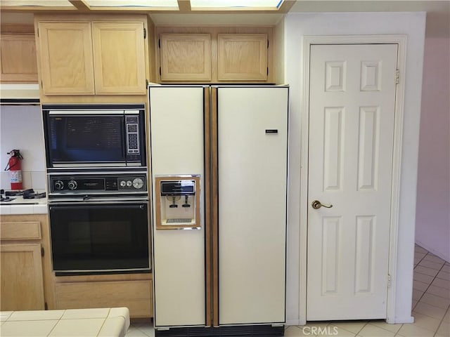 40132 Zamura Ct, Murrieta, CA 92562 - kitchen featuring white refrigerator with ice dispenser, black oven, tile counters, built in microwave, and light brown cabinetry