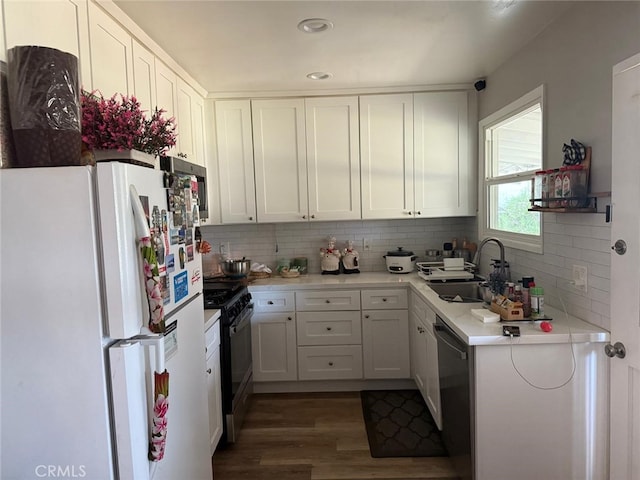 26261 Melba Ave, Homeland, CA 92548 - kitchen featuring freestanding refrigerator, black range with gas cooktop, dishwashing machine, a sink, and backsplash