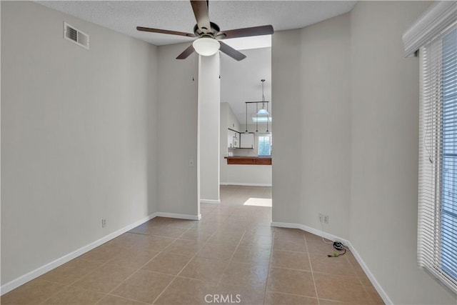 29331 Mawr Ct, Menifee, CA 92586 - empty room with ceiling fan, tile patterned flooring, baseboards, and a textured ceiling
