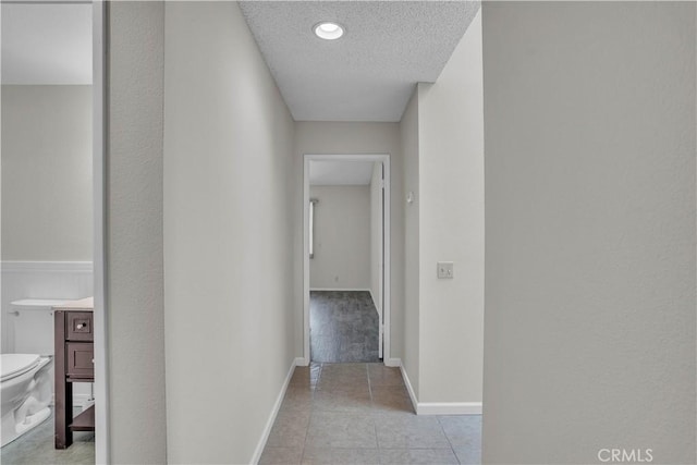 29331 Mawr Ct, Menifee, CA 92586 - hall with baseboards, light tile patterned floors, and a textured ceiling