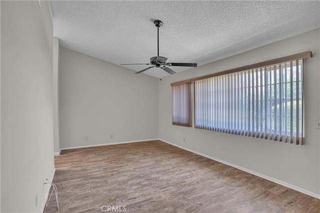 29331 Mawr Ct, Menifee, CA 92586 - empty room with a textured ceiling, wood finished floors, ceiling fan, and baseboards