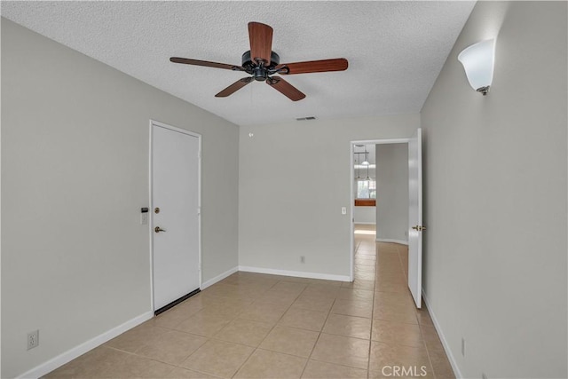 29331 Mawr Ct, Menifee, CA 92586 - spare room with a ceiling fan, a textured ceiling, light tile patterned flooring, and baseboards