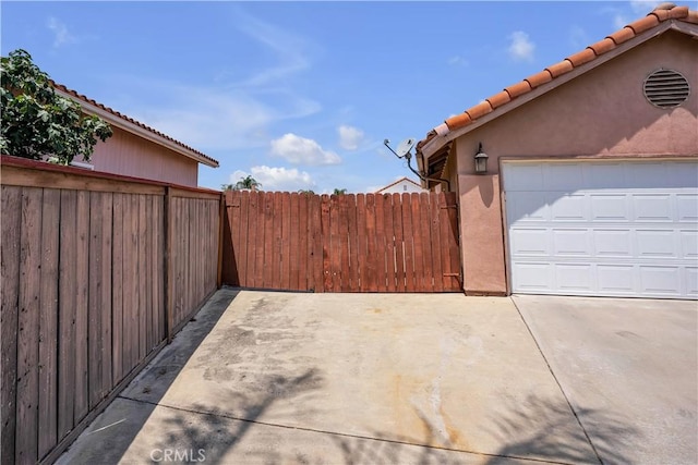 29331 Mawr Ct, Menifee, CA 92586 - view of side of home featuring a tiled roof, stucco siding, concrete driveway, and a garage