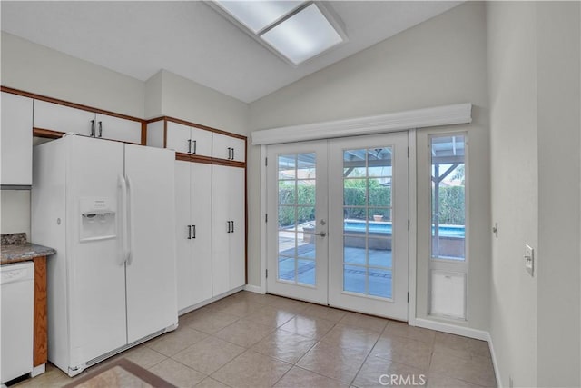 29331 Mawr Ct, Menifee, CA 92586 - doorway to outside with french doors, vaulted ceiling, light tile patterned floors, and baseboards