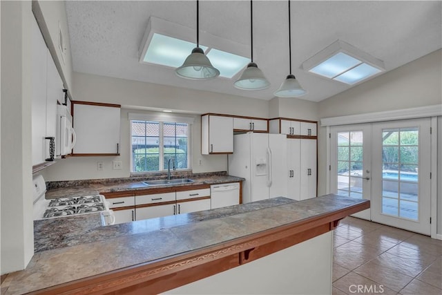 29331 Mawr Ct, Menifee, CA 92586 - kitchen featuring a sink, white appliances, dark countertops, a peninsula, and french doors