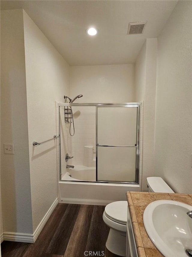 7331 Shelby Pl Unit 121, Rancho Cucamonga, CA 91739 - bathroom featuring wood finished floors, toilet, baseboards, combined bath / shower with glass door, and recessed lighting