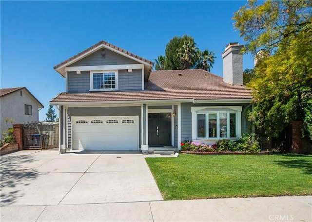 traditional-style house with a tile roof, driveway, an attached garage, and a chimney