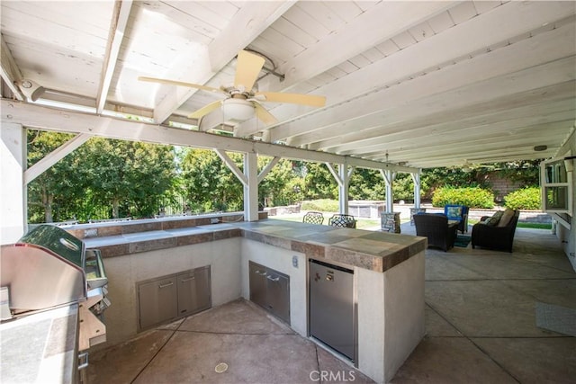 view of patio featuring area for grilling, a ceiling fan, and grilling area