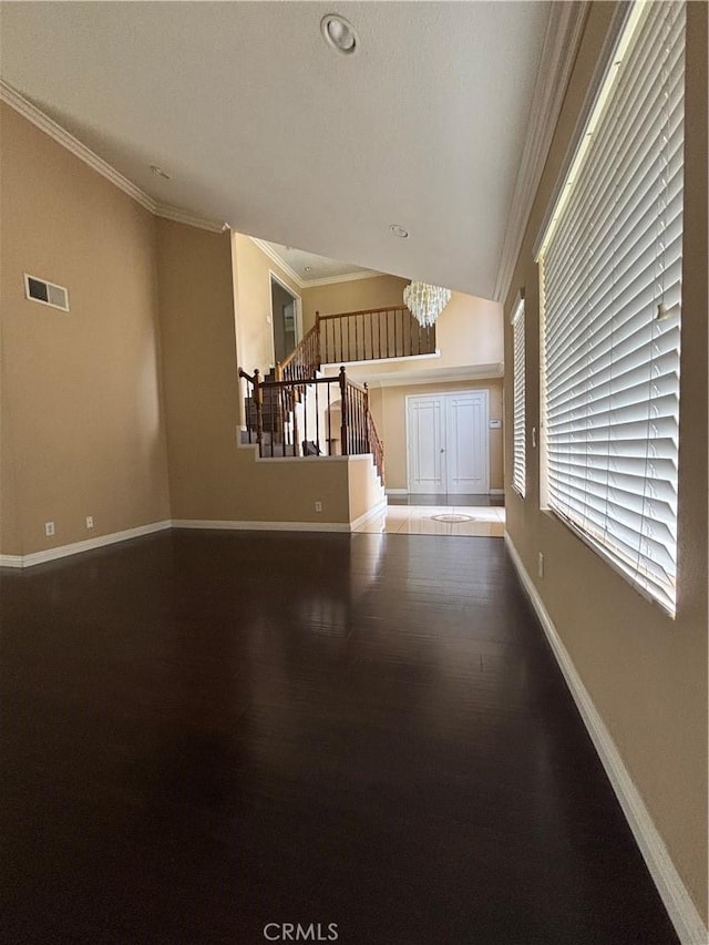 17092 Whispering Brook Way, Riverside, CA 92503 - unfurnished living room featuring baseboards, wood finished floors, stairs, a chandelier, and crown molding