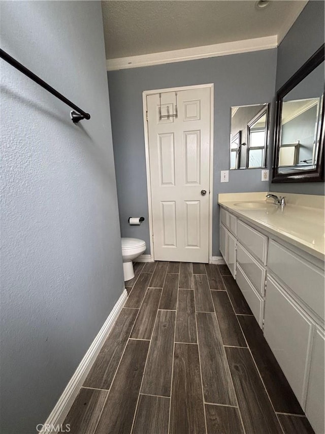 17092 Whispering Brook Way, Riverside, CA 92503 - bathroom with wood tiled floors, baseboards, ornamental molding, vanity, and toilet