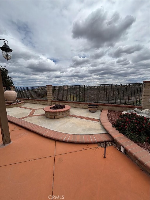 17092 Whispering Brook Way, Riverside, CA 92503 - view of patio / terrace with an outdoor fire pit and fence