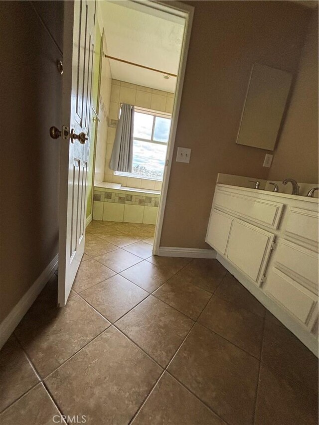 17092 Whispering Brook Way, Riverside, CA 92503 - bathroom with baseboards, tile patterned flooring, vanity, tiled bath, and a shower