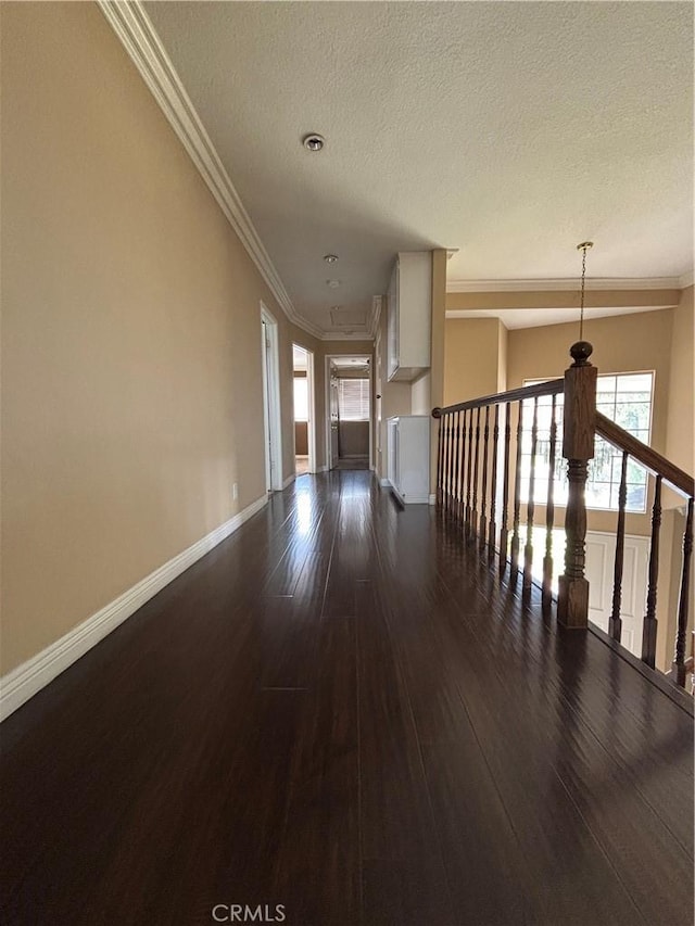 17092 Whispering Brook Way, Riverside, CA 92503 - hallway featuring dark wood-style flooring, a textured ceiling, ornamental molding, and baseboards