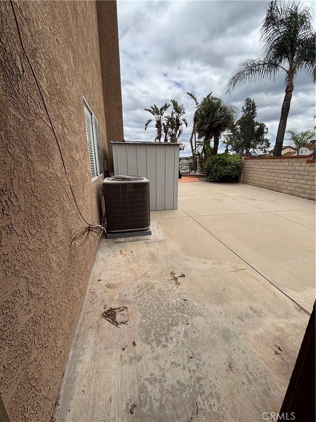 17092 Whispering Brook Way, Riverside, CA 92503 - view of home's exterior featuring central AC unit, a patio, stucco siding, and fence
