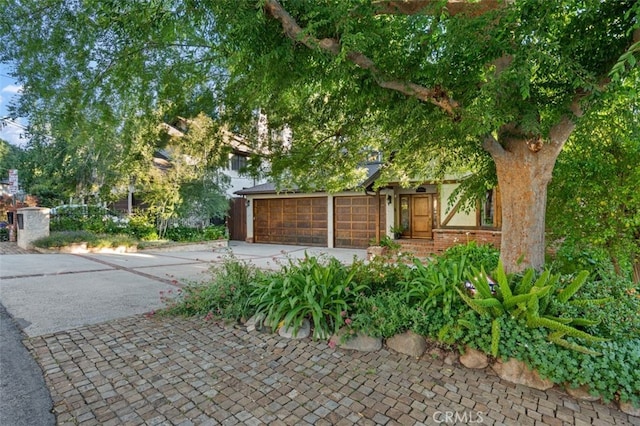 exterior space with concrete driveway and an attached garage