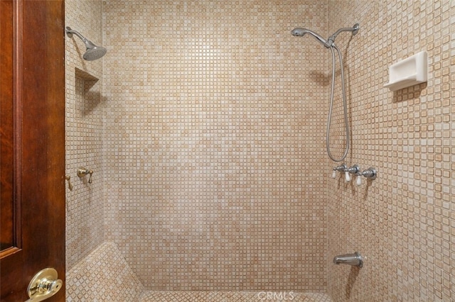 bathroom with tiled shower