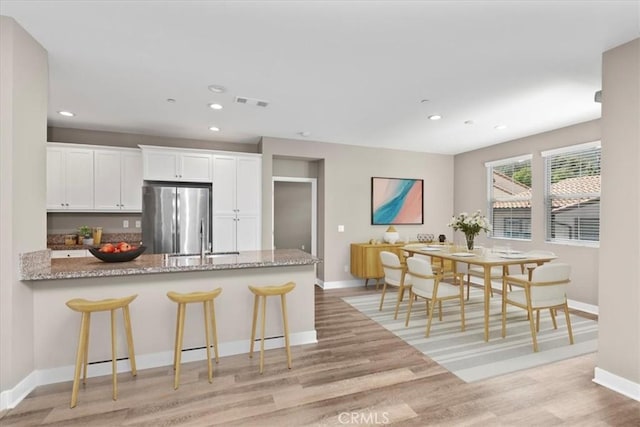 7501 Eagle Dr Unit 101, Santee, CA 92071 - kitchen featuring freestanding refrigerator, a sink, light wood-style flooring, light stone countertops, and recessed lighting