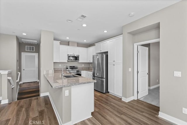 7501 Eagle Dr Unit 101, Santee, CA 92071 - kitchen with appliances with stainless steel finishes, white cabinetry, a peninsula, dark wood-style flooring, and recessed lighting