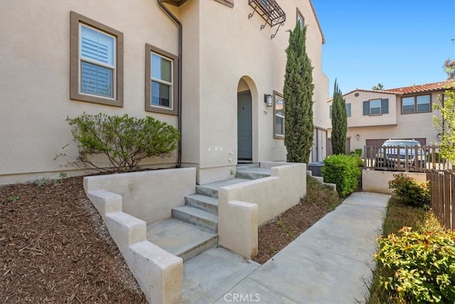 7501 Eagle Dr Unit 101, Santee, CA 92071 - doorway to property featuring stucco siding and fence