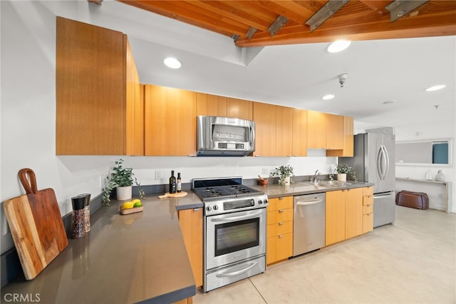 kitchen featuring stainless steel appliances, a sink, recessed lighting, and beam ceiling