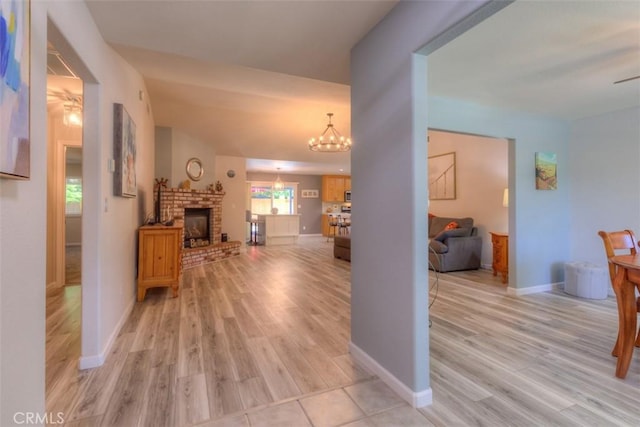 324 Crater Lake Dr, Chico, CA 95973 - corridor with a chandelier, light wood-style floors, and baseboards
