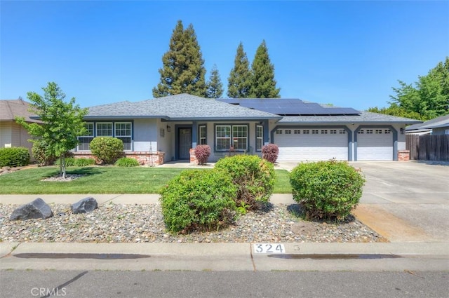 324 Crater Lake Dr, Chico, CA 95973 - ranch-style home featuring solar panels, an attached garage, driveway, and stucco siding