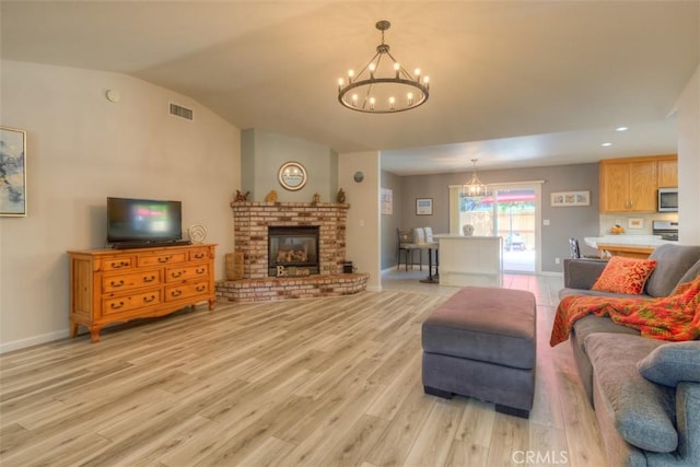 324 Crater Lake Dr, Chico, CA 95973 - living area with a chandelier, light wood-type flooring, lofted ceiling, a fireplace, and baseboards