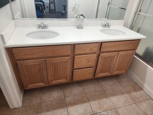 bathroom with double vanity, tile patterned flooring, and combined bath / shower with glass door