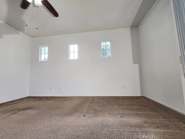 empty room featuring carpet flooring, ceiling fan, and baseboards