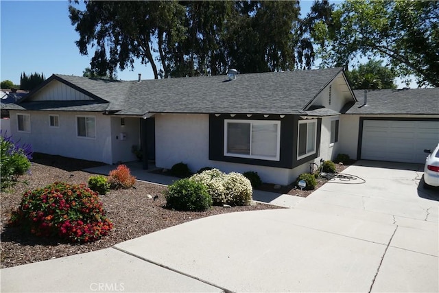 ranch-style house featuring driveway, a shingled roof, stucco siding, and an attached garage