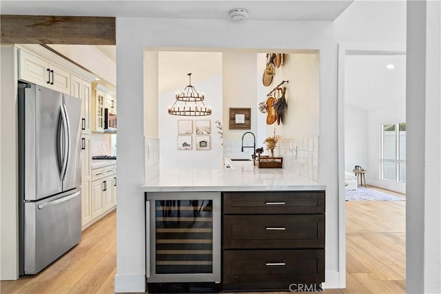249 Calle Empalme, San Clemente, CA 92672 - bar area featuring freestanding refrigerator, beverage cooler, decorative backsplash, a sink, and recessed lighting
