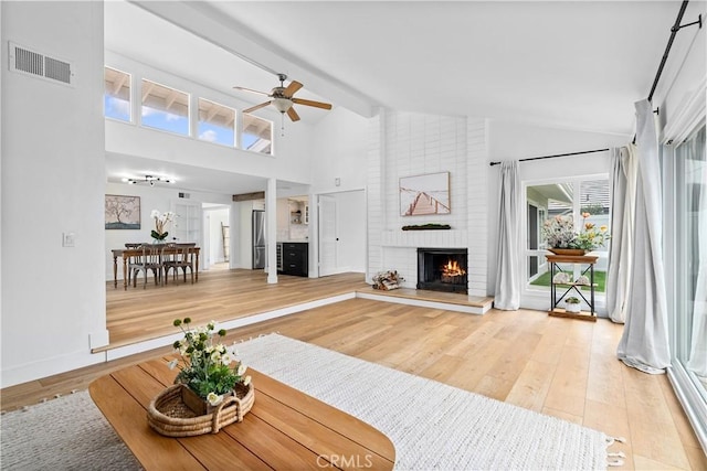 249 Calle Empalme, San Clemente, CA 92672 - living area featuring a fireplace, light wood finished floors, ceiling fan, high vaulted ceiling, and baseboards