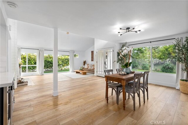 249 Calle Empalme, San Clemente, CA 92672 - dining space with healthy amount of natural light, light wood-type flooring, and vaulted ceiling