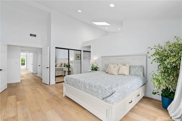 249 Calle Empalme, San Clemente, CA 92672 - bedroom featuring high vaulted ceiling, a skylight, light wood finished floors, recessed lighting, and baseboards