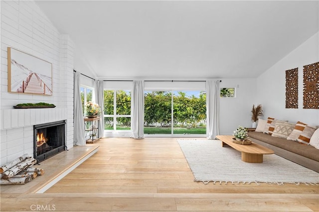 249 Calle Empalme, San Clemente, CA 92672 - living room with vaulted ceiling, wood finished floors, and a fireplace