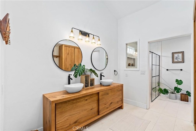 249 Calle Empalme, San Clemente, CA 92672 - bathroom featuring double vanity, lofted ceiling, an enclosed shower, baseboards, and tile patterned floors